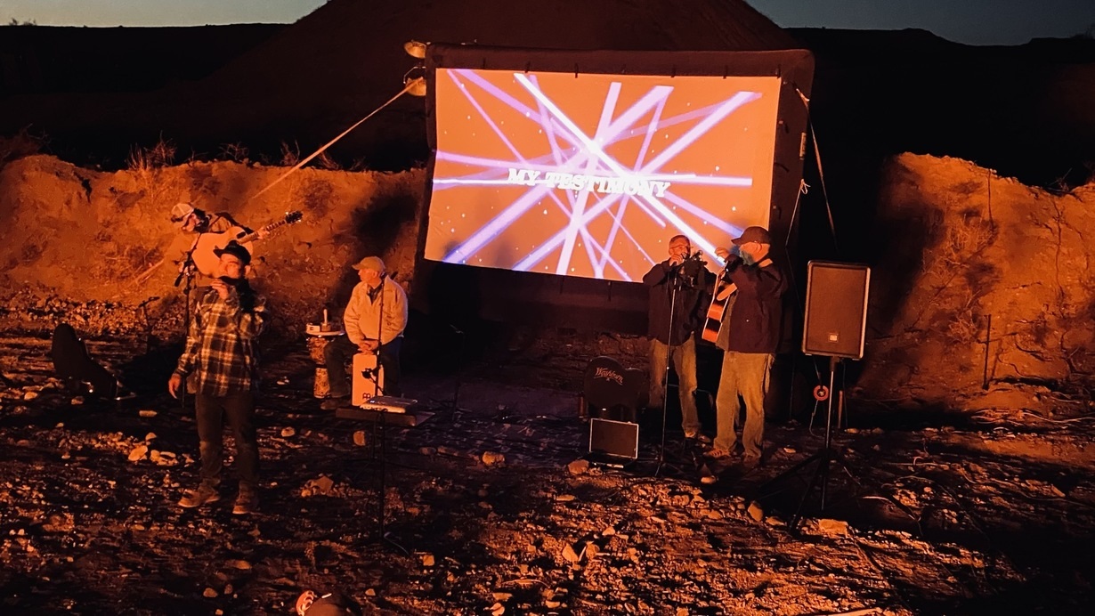 Group performing outside with lights display