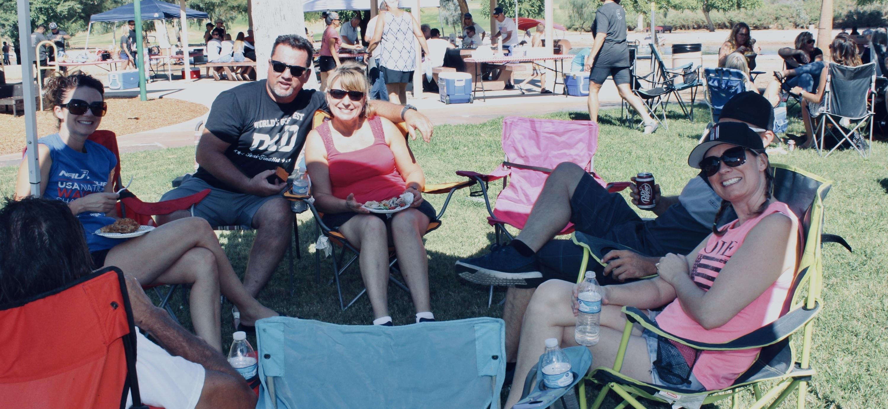 People sitting and smiling at park gathering